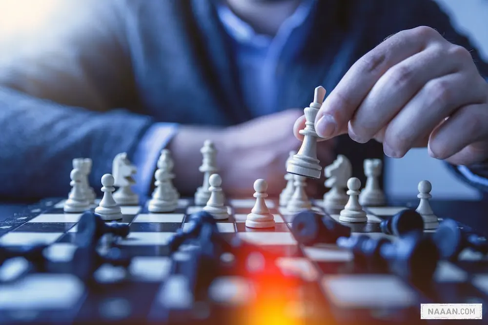 depth of field photography of man playing chess